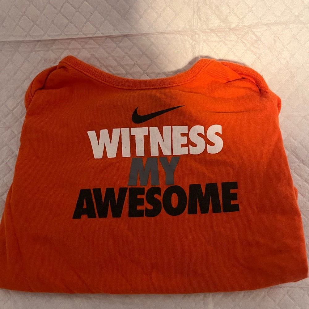 Orange gender neutral onesie. Never worn - without tags